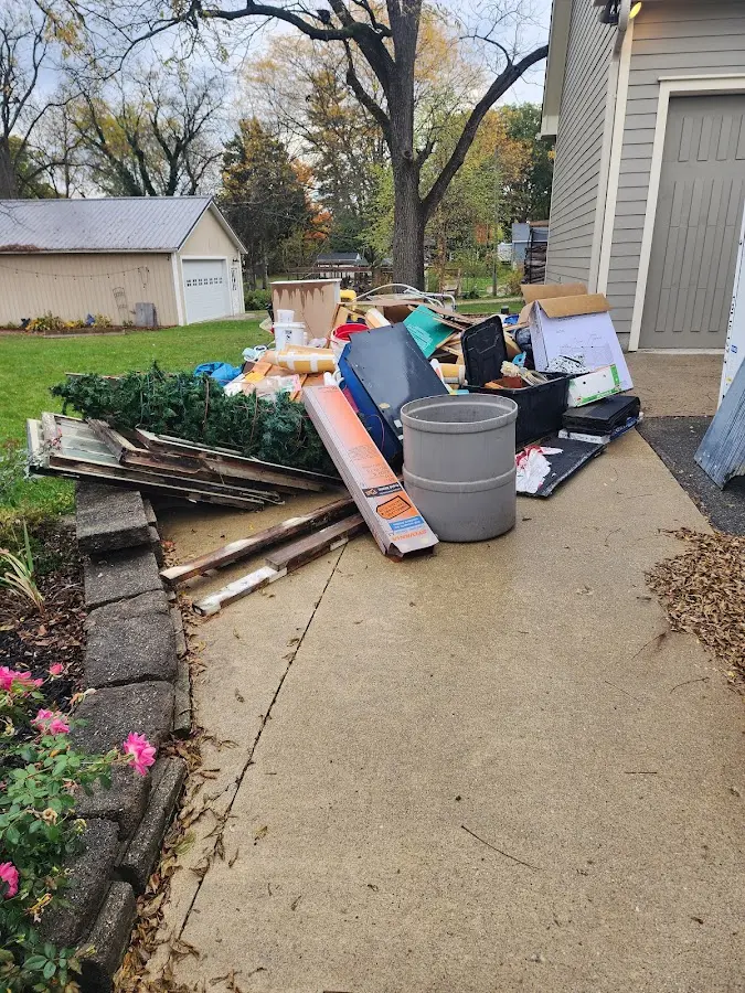 Dumpster being loaded with debris for 3 Yard Dumpster Rental in Avondale